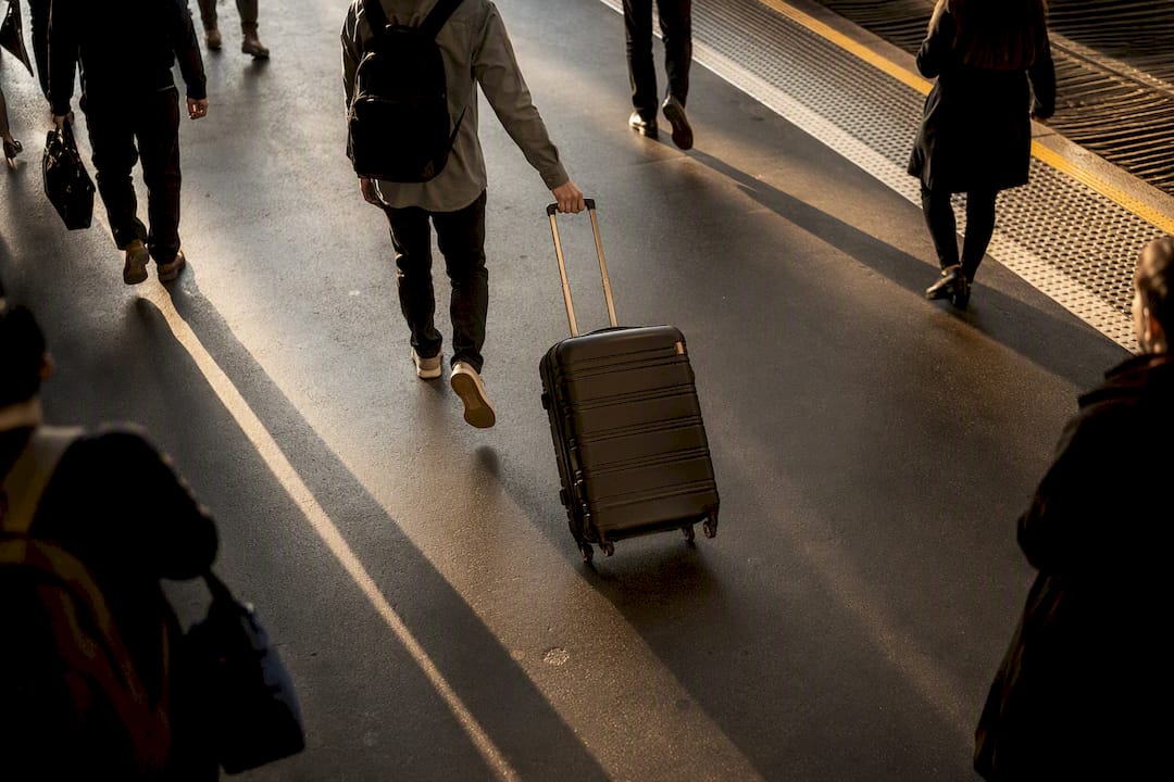 Commuter handling luggage on Blue Mountains train platform stairs